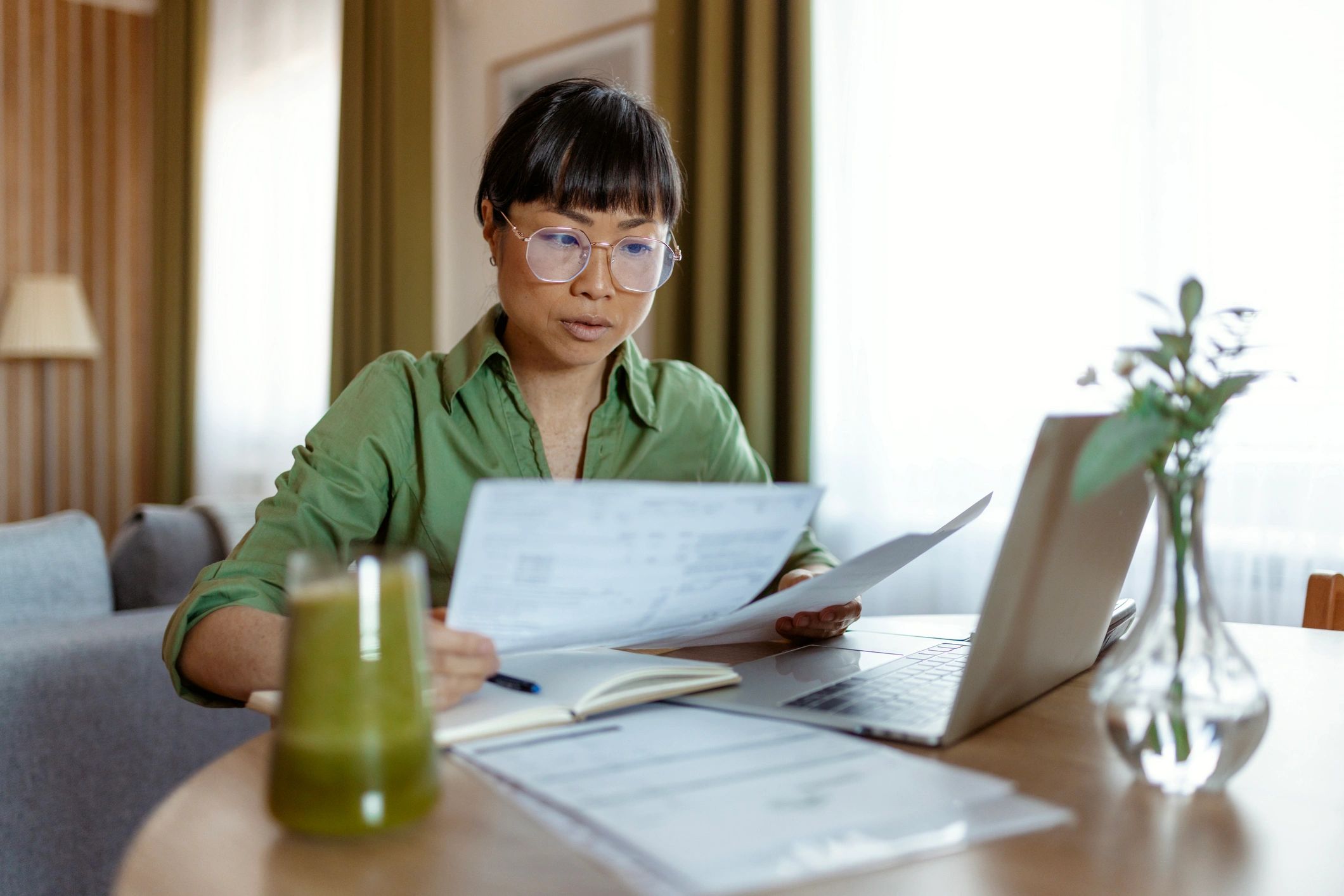 Homeowner reviewing mortgage documents at a home office